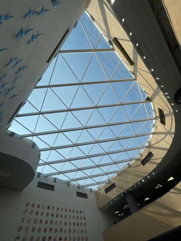 Triangulated glass skylight over the BITSOM academic atrium viewed from below